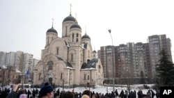 FILE —People gather outside the Church of the Icon of the Mother of God Soothe My Sorrows, in Moscow, Russia, March 1, 2024.