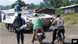 In this May 21, 2013 photo, a United Nations tank stands guard along a roadside near Goma, DRC.