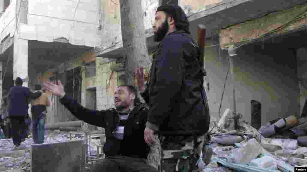 A man reacts at the site of what activists said was an air raid by forces loyal to Syrian President Bashar Al-Assad in the al-Marja district of Aleppo, Dec. 23, 2013.&nbsp;