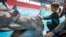 A girl touches a dolphin during a dolphin therapy session at the Nemo Dolphinarium in Kyiv, Ukraine. 