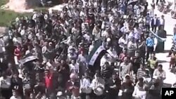 Syrians chanting slogans during a demonstration in Idlib, Syria, April 12, 2012. (AP cannot independently verify the content, date, location or authenticity of this material.)