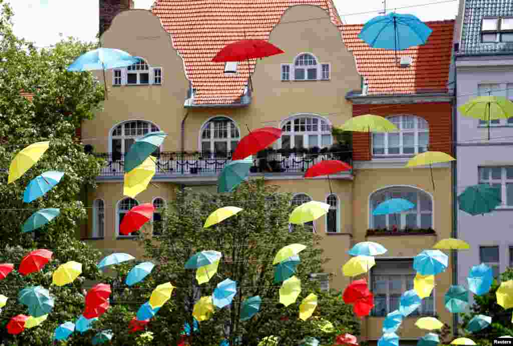 Colored umbrellas are hung to celebrate an upcoming wine festival at Berlin's Charlottenburg district in Berlin, Germany.