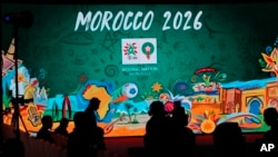FILE - In this March 17, 2018 file photo, a giant screen displays the logo of Morocco 2026 before a press conference to promote Morocco's bid for the 2026 soccer World Cup in Casablanca, Morocco.