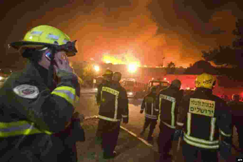 Firefighters try to prevent a widfire from reaching the town of Tirat Hacarmel, northern Israel, Thursday, Dec. 2, 2010. A massive forest fire that scorched part of northern Israel killed scores of people Thursday, officials said. Fire officials said the 