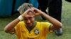 Brazil's Neymar forms a heart with his hands as he leaves the pitch after the World Cup round of 16 soccer match between Brazil and Chile at the Mineirao Stadium in Belo Horizonte, Brazil, Saturday, June 28, 2014. Brazil won 3-2 on penalties after the mat