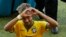 Brazil's Neymar forms a heart with his hands as he leaves the pitch after the World Cup round of 16 soccer match between Brazil and Chile at the Mineirao Stadium in Belo Horizonte, Brazil, Saturday, June 28, 2014. Brazil won 3-2 on penalties after the mat