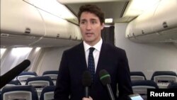 Canada’s Prime Minister Justin Trudeau apologizes for wearing brown face makeup in 2001, to reporters on the Liberal party leader’s election campaign jet in Halifax, Nova Scotia, Canada, Sept 18, 2019. 