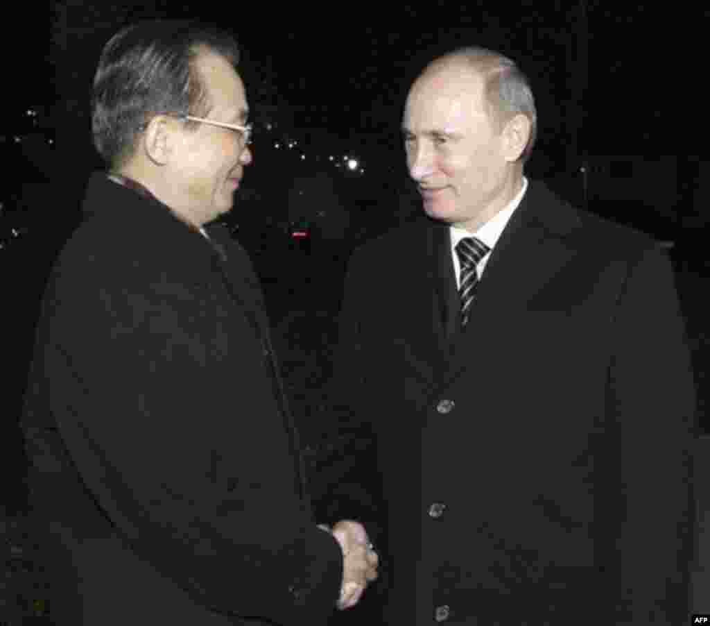 Russian Prime Minister Vladimir Putin, right, greets his Chinese counterpart Wen Jiabao in St. Petersburg, Russia, Monday, Nov. 22, 2010. (AP Photo/RIA Novosti, Alexei Druzhinin, Pool)