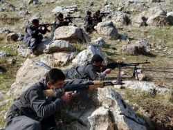 FILE - Recruits of the Kurdistan Free Life Party, a splinter group of the PKK, the Kurdistan Workers' Party, take defensive positions near their training camp in the Qandil mountain range, northern Iraq.