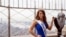 In this Sept. 12, 2017, file photo, newly-crowned Miss America 2018 Cara Mund poses for photographers on the 86th Floor Observation Deck of the Empire State Building, in New York. Mund will be the last Miss America to have worn a swimsuit onstage.