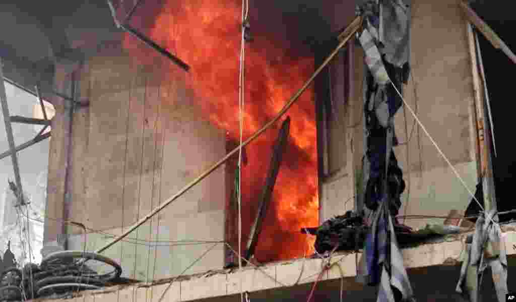 This image made from video and posted online from Validated UGC, shows a building on fire after airstrikes hit Aleppo, April 28, 2016. The new violence brings the death toll in the past 24-hours in the deeply divided city to at least 61 killed.