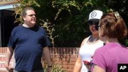 David Veatch, left, the father of plane-crash survivor Autumn Veatch, 16, walks away after speaking to reporters waiting at the entrance of the Okanogan Douglas Hospital in Brewster, Wash., July 14, 2015. 