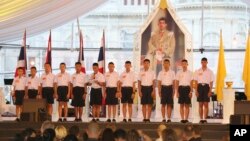 FILE - Members of the Wild Boars, the soccer team that was rescued from a flooded cave, give thanks in front of Thailand King Maha Vajiralongkorn's image during an event titled "United as One" in Bangkok, Thailand, Sept. 6, 2018. 