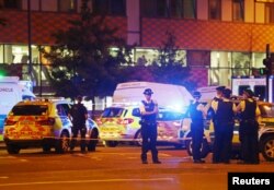 Police officers attend to the scene after a vehicle collided with pedestrians in the Finsbury Park neighborhood of North London, Britain, June 19, 2017.