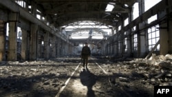 FILE - An Ukrainian serviceman walks through the rubble of a destroyed factory after fighting with pro-Russian separatists in Avdiivka, Donetsk region, eastern Ukraine, March 31, 2017. 