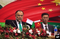 FILE - Ahsan Iqbal (L), Pakistan's Minister of Planning and Development and Yao Jing, Chinese Ambassador to Pakistan attend the launching ceremoney of CPEC long-term cooperation plan in Islamabad, Pakistan December 18, 2017.