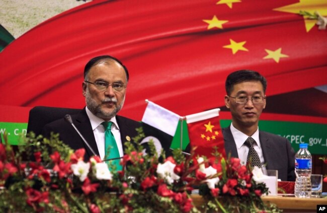FILE - Ahsan Iqbal (L), Pakistan's Minister of Planning and Development and Yao Jing, Chinese Ambassador to Pakistan attend the launch ceremony of CPEC long-term cooperation plan in Islamabad, Pakistan, Dec. 18, 2017.