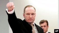 FILE - Anders Behring Breivik gestures as he arrives at a courtroom in Oslo, Norway, April 17, 2012. Breivik, the right-wing extremist who killed 77 people in attacks in 2011, had sued Norway's government for human rights violations for keeping him imprisoned in isolation.