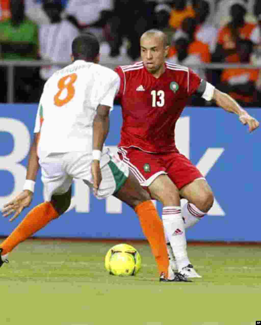 Morocco's Houssine Kharja (13) dribbles the ball against Niger's Harouna Olivier (8) during their final African Cup of Nations Group C soccer match at the Stade De L'Amitie Stadium in Libreville, Gabon January 31, 2012.