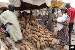 A woman shops for yams that have risen in price due to changes in Nigeria's fuel subsidy at Mile 12 market in Lagos, January 14, 2012.