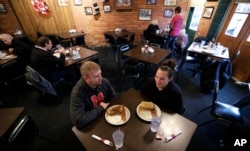 Eddie Kramer eats breakfast with his wife, Abby, at the Engine House Cafe in Lincoln, Nebraska, Jan. 4, 2017.