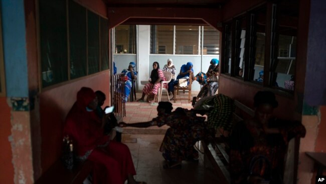 Pregnant women wait to be assisted at the Bundung Maternal and Child Health Hospital in Serrekunda, outskirts of Banjul, Gambia, Sept. 23, 2021.