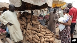 FILE: A woman shops for yams that have risen in price due to changes in Nigeria's fuel subsidy at Mile 12 market in Lagos, January 14, 2012.