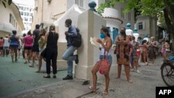 People wait in line to be tested for COVID-19 outside the Manoel Jose Ferreira public health care unit in Rio de Janiero, Brazil, Jan. 5, 2022. 