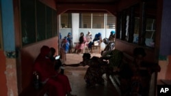 Pregnant women wait to be assisted at the Bundung Maternal and Child Health Hospital in Serrekunda, outskirts of Banjul, Gambia, Sept. 23, 2021. 