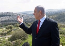 FILE - Prime Minister Netanyahu delivers a statement overlooking the Israeli settlement of Har Homa, in an area of Israeli-occupied West Bank, that Israel annexed to Jerusalem after the region's capture in 1967 Middle East war, Feb. 20, 2020.