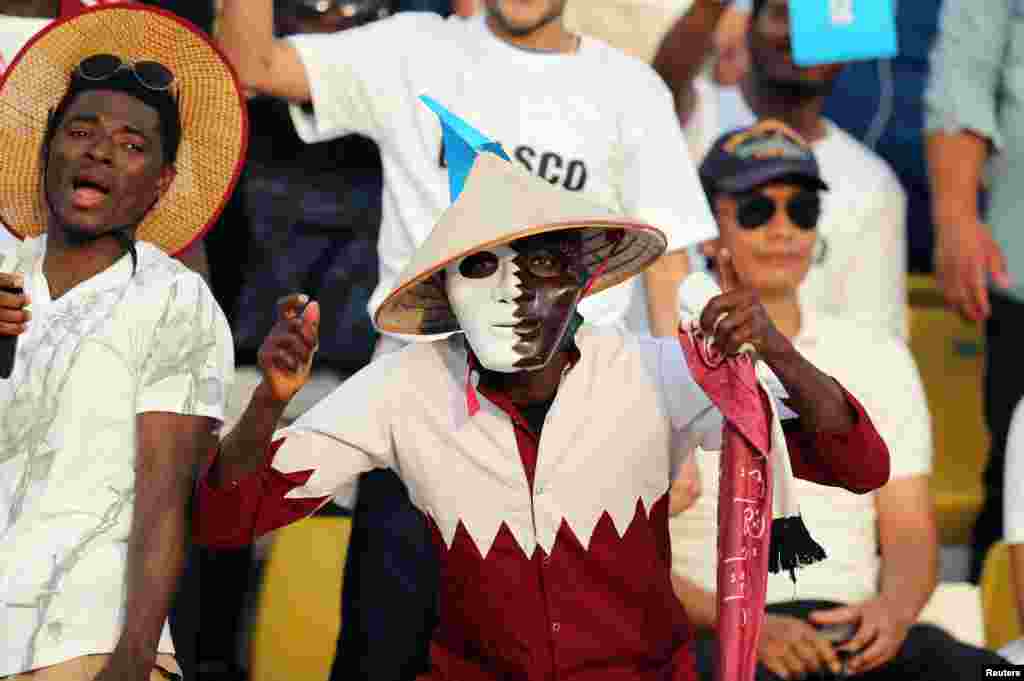 Migrant workers cheer before the start of the final soccer match between Al Asmakh Facilities Management and Nakheel Landscapes at the Workers&#39; Cup in Doha, Qatar.
