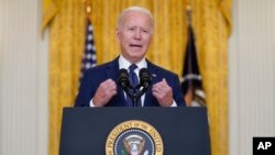 FILE - President Joe Biden speaks about the bombings at the Kabul airport, from the East Room of the White House, Aug. 26, 2021.