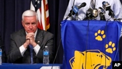 Pennsylvania Governor Tom Corbett waits to speak to a gathering of reporters at the Franklin Regional School District Middle School, April 9, 2014.