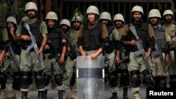 Ranger soldiers stand guard against supporters of Mohammad Tahir ul-Qadri, Sufi cleric and leader of political party Pakistan Awami Tehreek, during the Revolution March to the parliament house in Islamabad, Aug. 20, 2014.