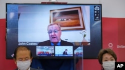 CEO of the Tokyo 2020 Toshiro Muto (L) and President of the Tokyo 2020 Seiko Hashimoto (R) listen to International Olympic Committee vice president John Coates (on screen) delivering a speech during a press conference in Tokyo, Japan, May 21, 2021.