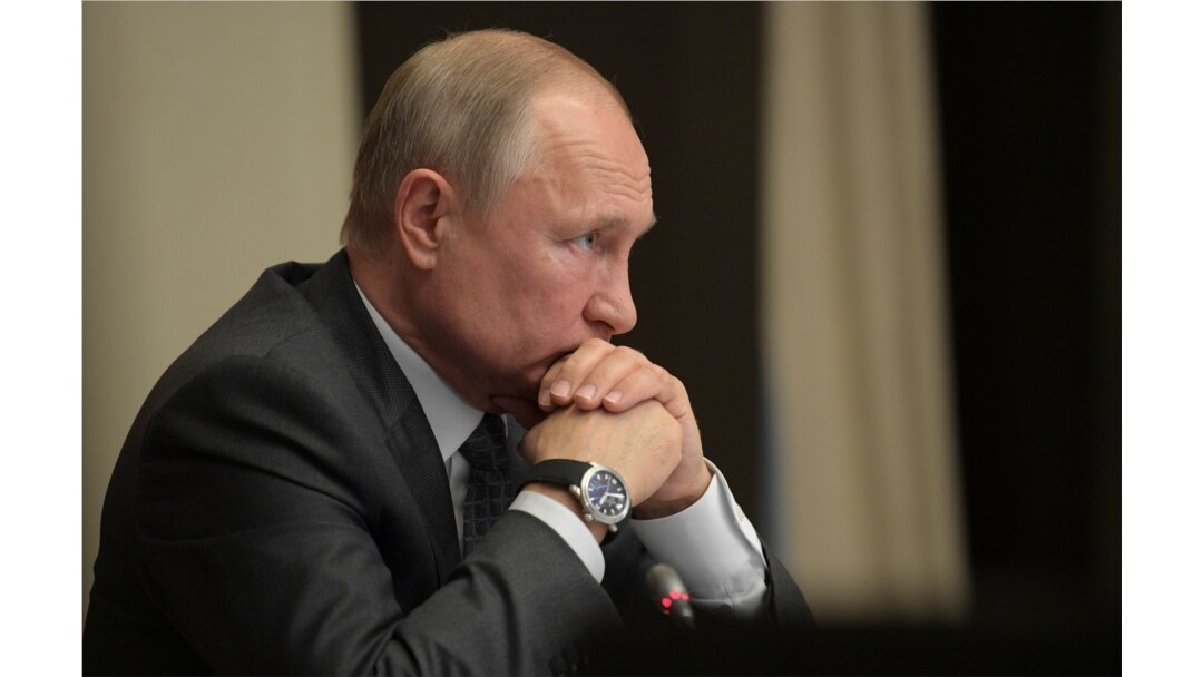 FILE - Russian President Vladimir Putin chairs a meeting at the Novo-Ogaryovo state residence outside Moscow, Russia, Oct. 16, 2019.