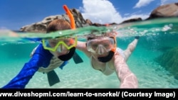 Family snorkeling in tropical water