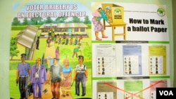 Kenyan elections posters discussed during an IEBC politician education forum in Mombasa, Kenya, Feb. 18, 2013." (Jill Craig/VOA)