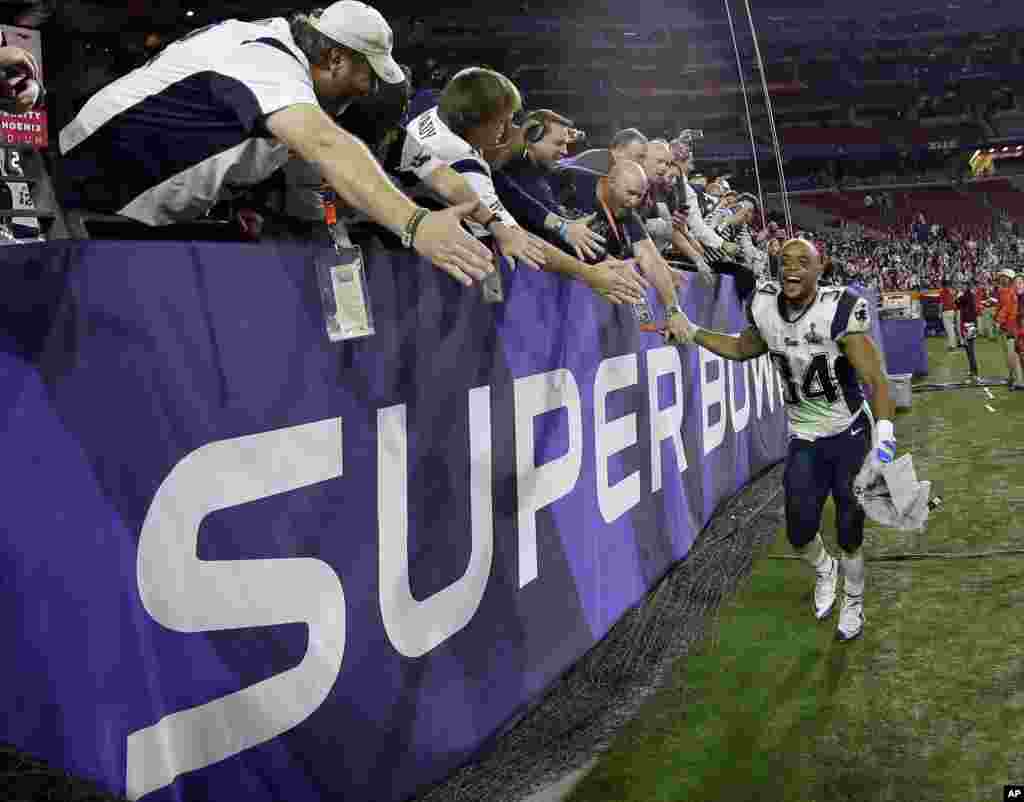 New England Patriots running back Shane Vereen (34) celebrates with fans after the NFL Super Bowl XLIX football game against the Seattle Seahawks in Glendale, AZ.