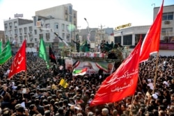 In this photo provided by he Iranian Students News Agency, ISNA, flag-draped coffins of Gen. Qassem Soleimani and his comrades are seen during a tribute in the southwestern city of Ahvaz, Iran, Jan. 5, 2020.