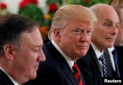 U.S. President Donald Trump flanked by Secretary of State Mike Pompeo and White House Chief of Staff John Kelly attend a lunch with Singapore's Prime Minister Lee Hsien Loong and officials at the Istana in Singapore, June 11, 2018.