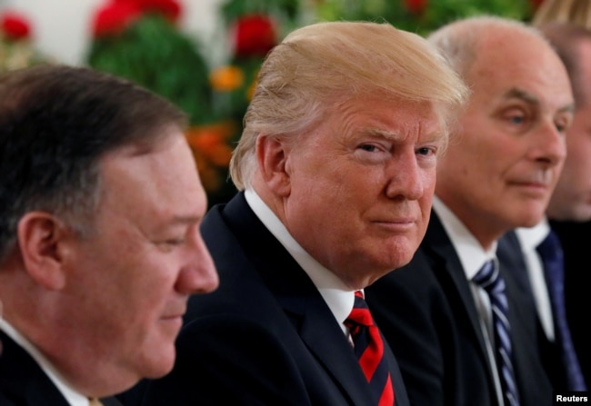 U.S. President Donald Trump flanked by Secretary of State Mike Pompeo and White House Chief of Staff John Kelly attend a lunch with Singapore's Prime Minister Lee Hsien Loong and officials at the Istana in Singapore, June 11, 2018.