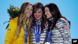 Women's snowboard halfpipe medalists, from left, Torah Bright of Australia, silver, Kaitlyn Farrington of the United States, gold, and Kelly Clark of the United States, bronze, pose with their medals at the 2014 Winter Olympics in Sochi, Feb. 13, 2014. 