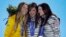 Women's snowboard halfpipe medalists, from left, Torah Bright of Australia, silver, Kaitlyn Farrington of the United States, gold, and Kelly Clark of the United States, bronze, pose with their medals at the 2014 Winter Olympics in Sochi, Feb. 13, 2014. 