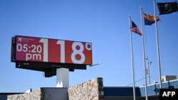 FILE - A billboard displays a temperature of 118 degrees Fahrenheit (48 degrees Celcius) during a record heat wave in Phoenix, Arizona, on July 18, 2023.