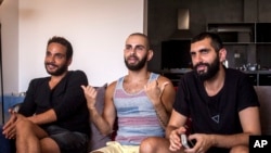 This July 27, 2015 photo shows Khader Abu Seif, from left, Naeem Jiryes and Fadi Daeem, protagonists of the documentary movie "Oriented" during an interview with The Associated Press in Jaffa, mixed Jewish-Arab part of Tel Aviv, Israel. 