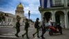 FILE - Police officers walk near the Havana Capitol, Nov. 15, 2021. The Cuban opposition planned to take to city streets that day to demand the release of political prisoners, but the Cuban government banned the demonstration.