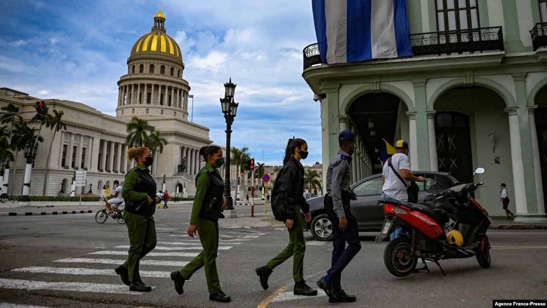 FILE - Police officers walk near the Havana Capitol, Nov. 15, 2021. The Cuban opposition planned to take to city streets that day to demand the release of political prisoners, but the Cuban government banned the demonstration.