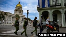 FILE - Police officers walk near the Havana Capitol, Nov. 15, 2021. The Cuban opposition planned to take to city streets that day to demand the release of political prisoners, but the Cuban government banned the demonstration.