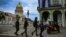 FILE - Police officers walk near the Havana Capitol, Nov. 15, 2021. The Cuban opposition planned to take to city streets that day to demand the release of political prisoners, but the Cuban government banned the demonstration.